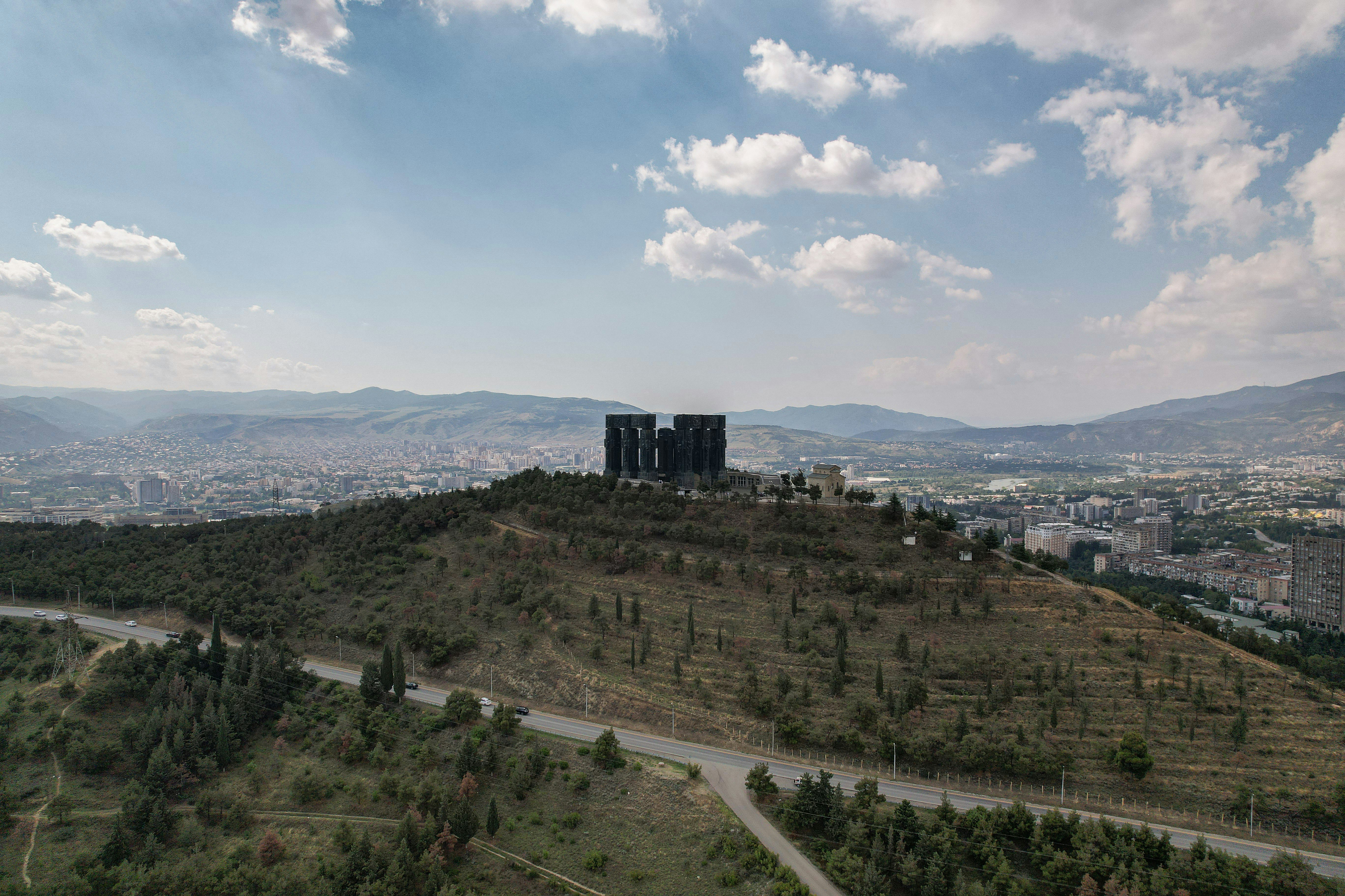 A large building on top of a hill photo – Free Tbilisi Image on Unsplash