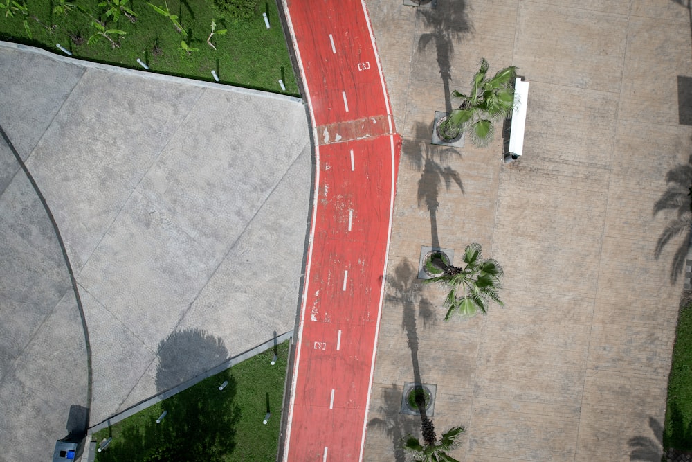 an aerial view of a street with a red curb