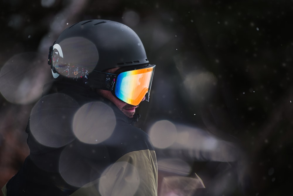 a man wearing a helmet and goggles in the snow