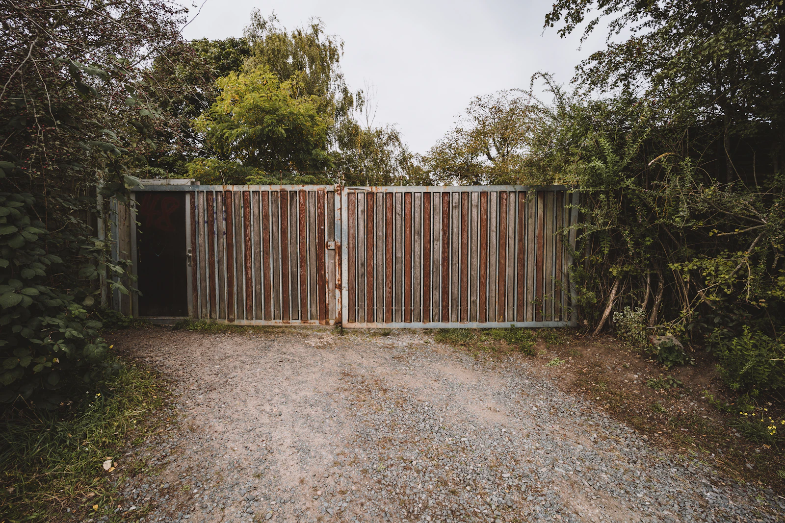 Double driveway gate flanked by stone pillars