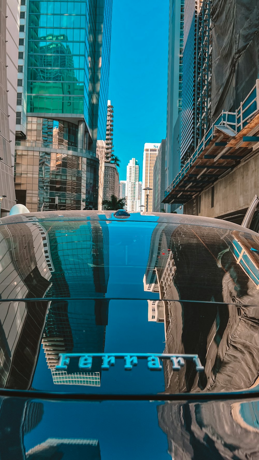 a reflection of a building in the windshield of a car