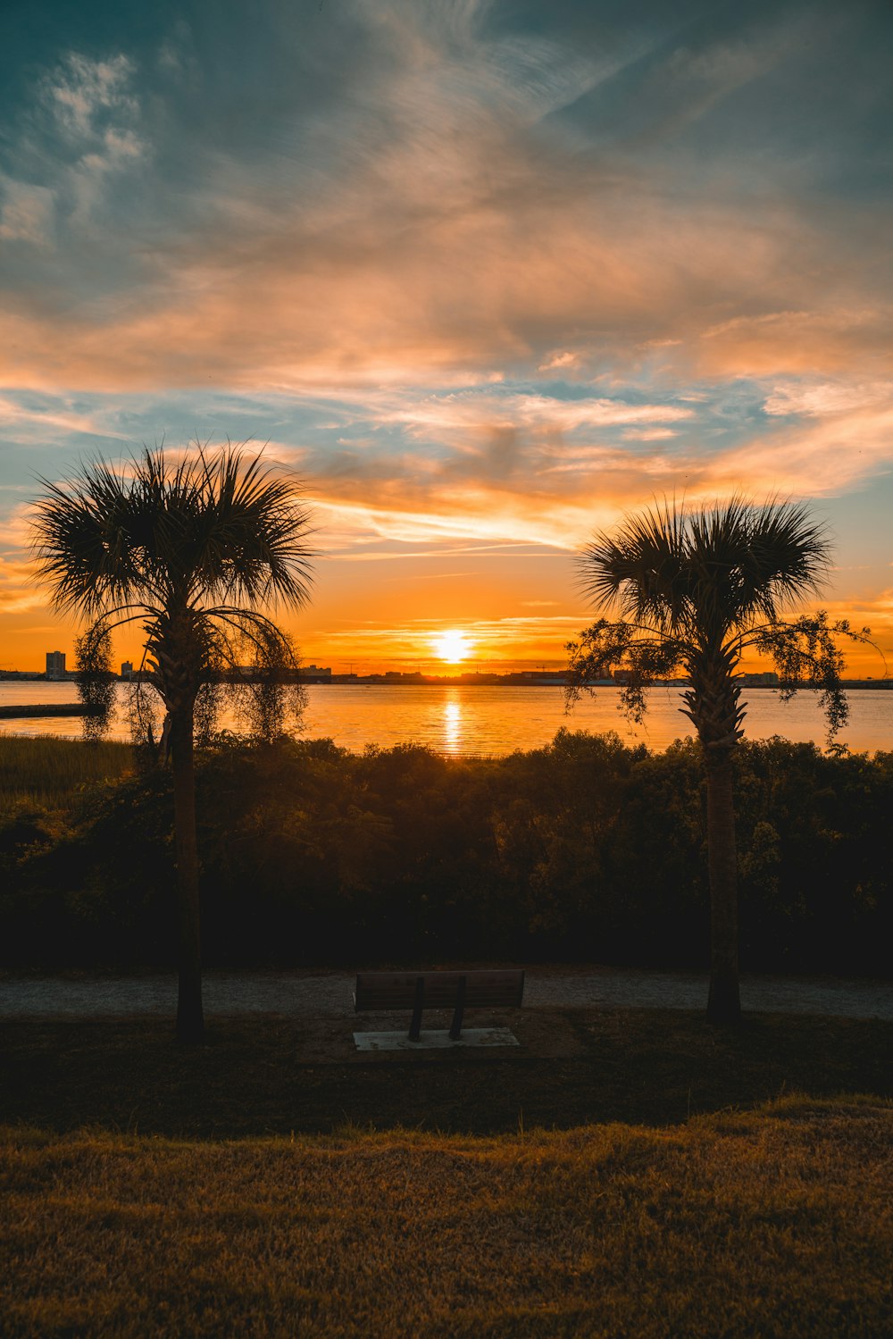 the sun is setting over a body of water