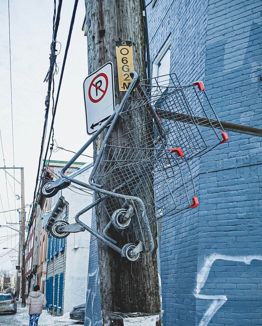 a wire basket hanging from a telephone pole