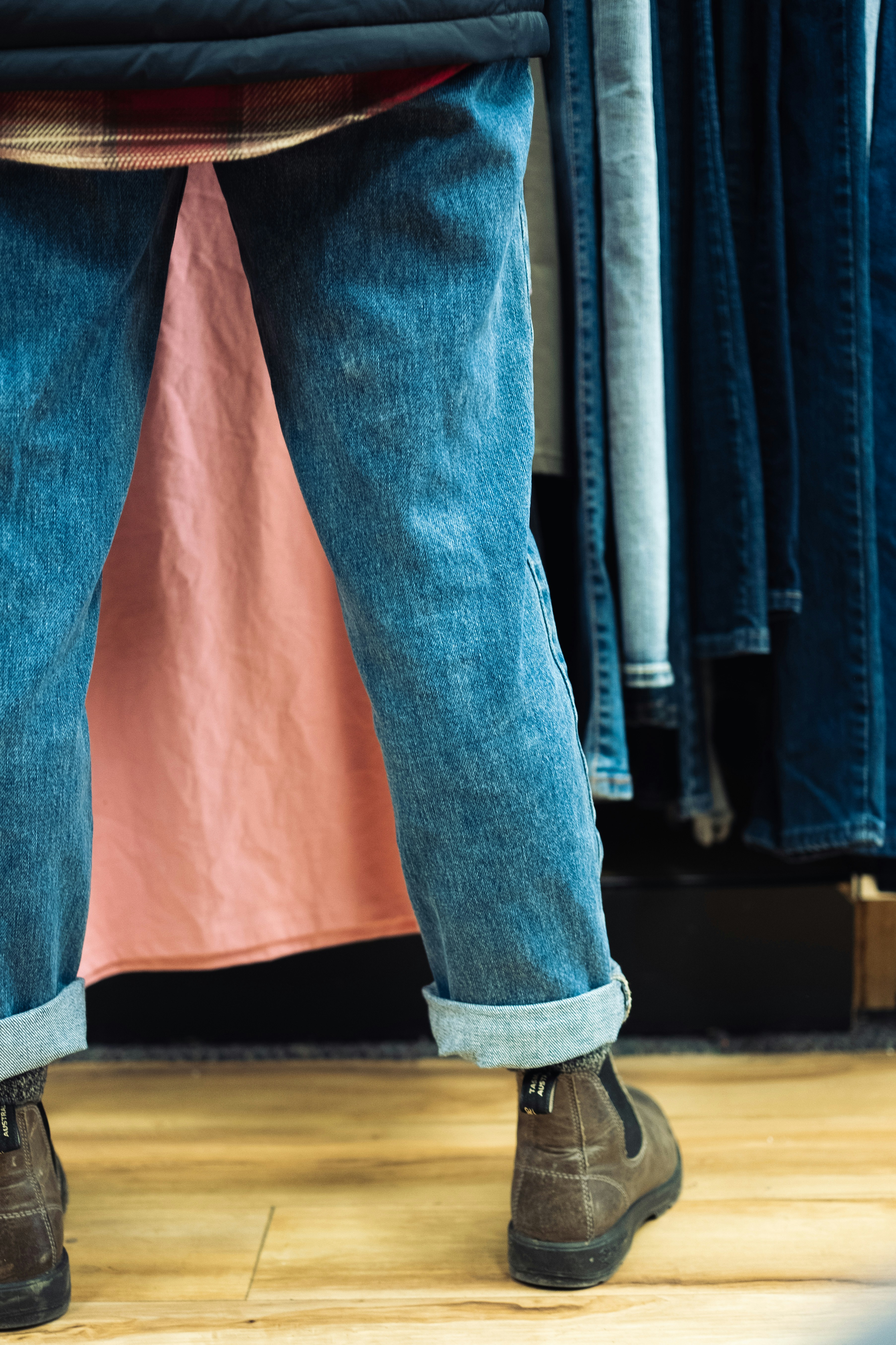 How to Make Cheap Clothes Look Expensive: 6 Insider Tricks Stylists Use – a person standing in front of a rack of clothes