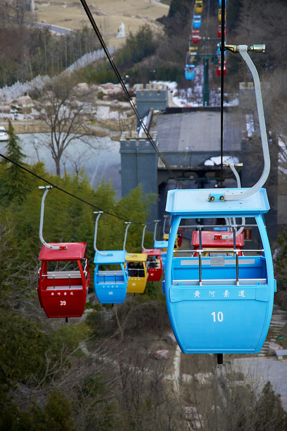 a blue and red ski lift going up a hill