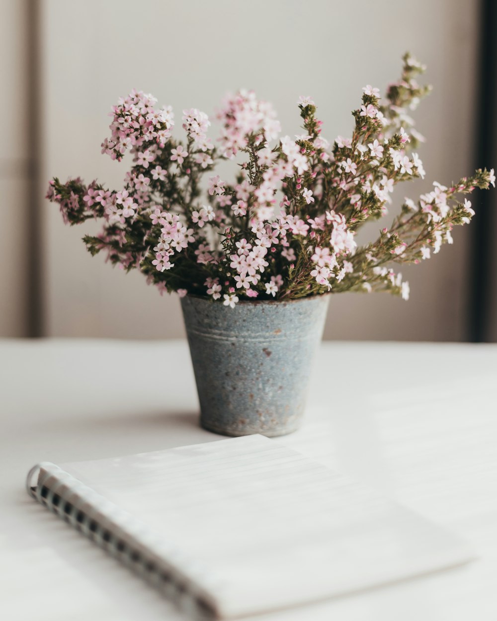 a vase of flowers sitting on top of a table