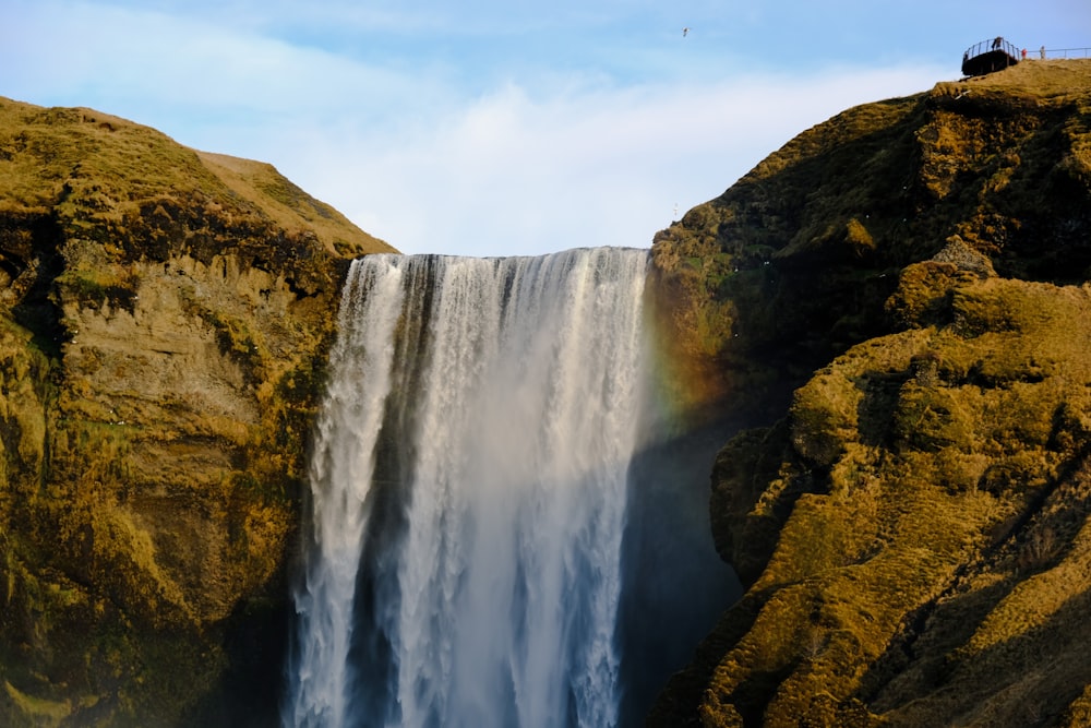 a waterfall with a rainbow in the middle of it