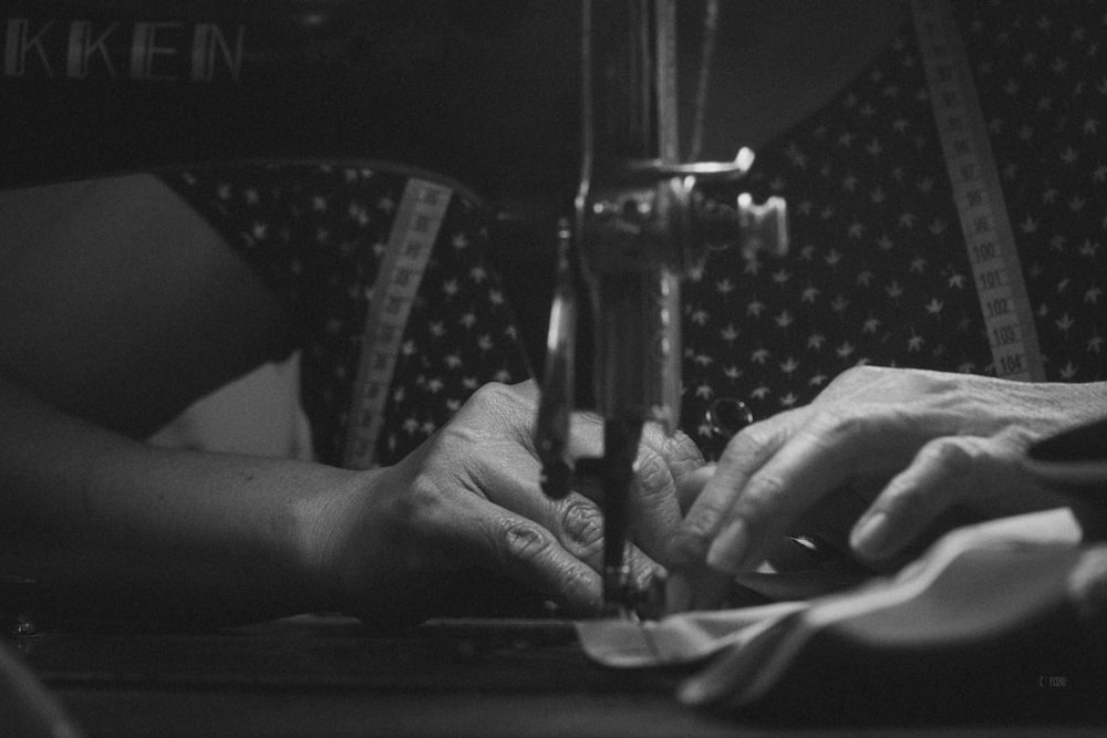 a woman is using a sewing machine to sew