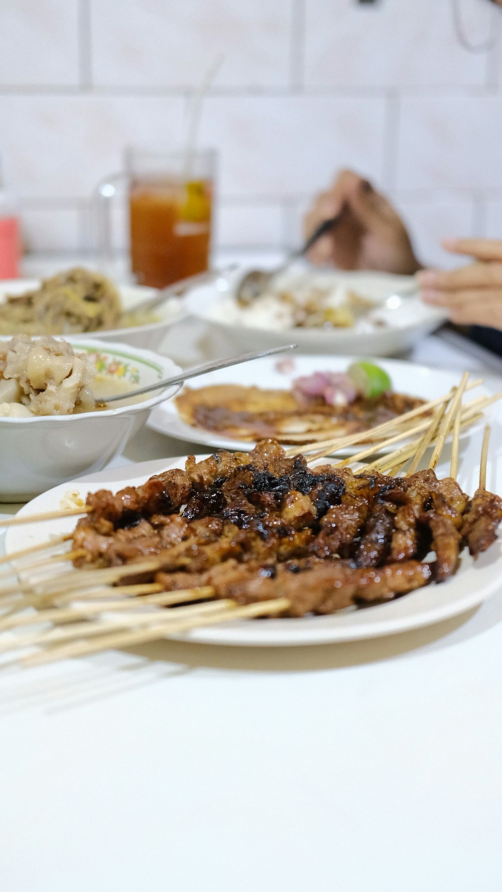 a table topped with plates of food covered in meat