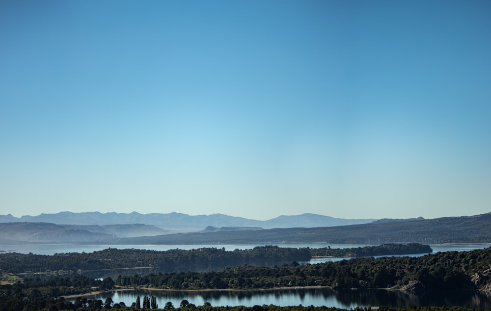 a scenic view of a lake surrounded by mountains