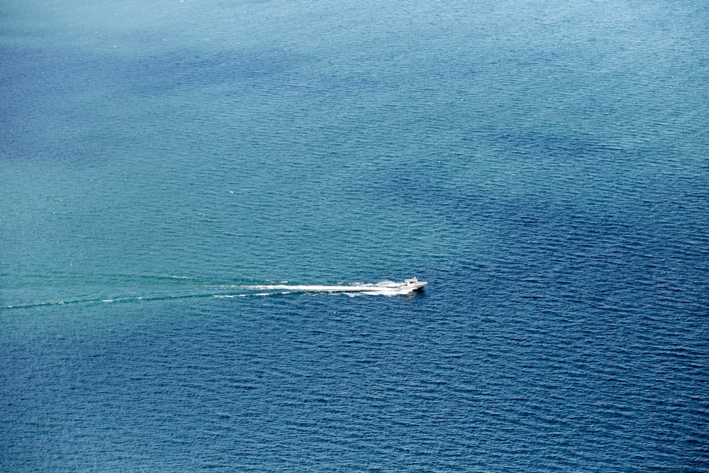 a small boat in the middle of a large body of water