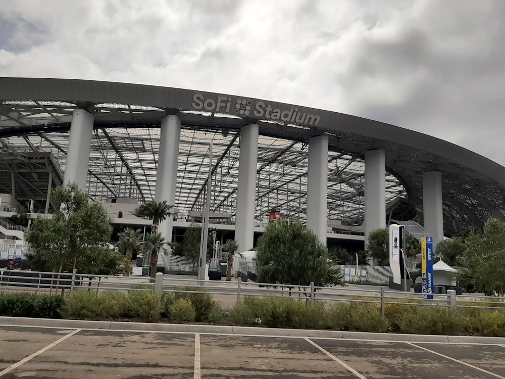 an empty parking lot in front of a large building