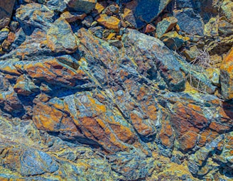 a close up of a rock with yellow and blue colors
