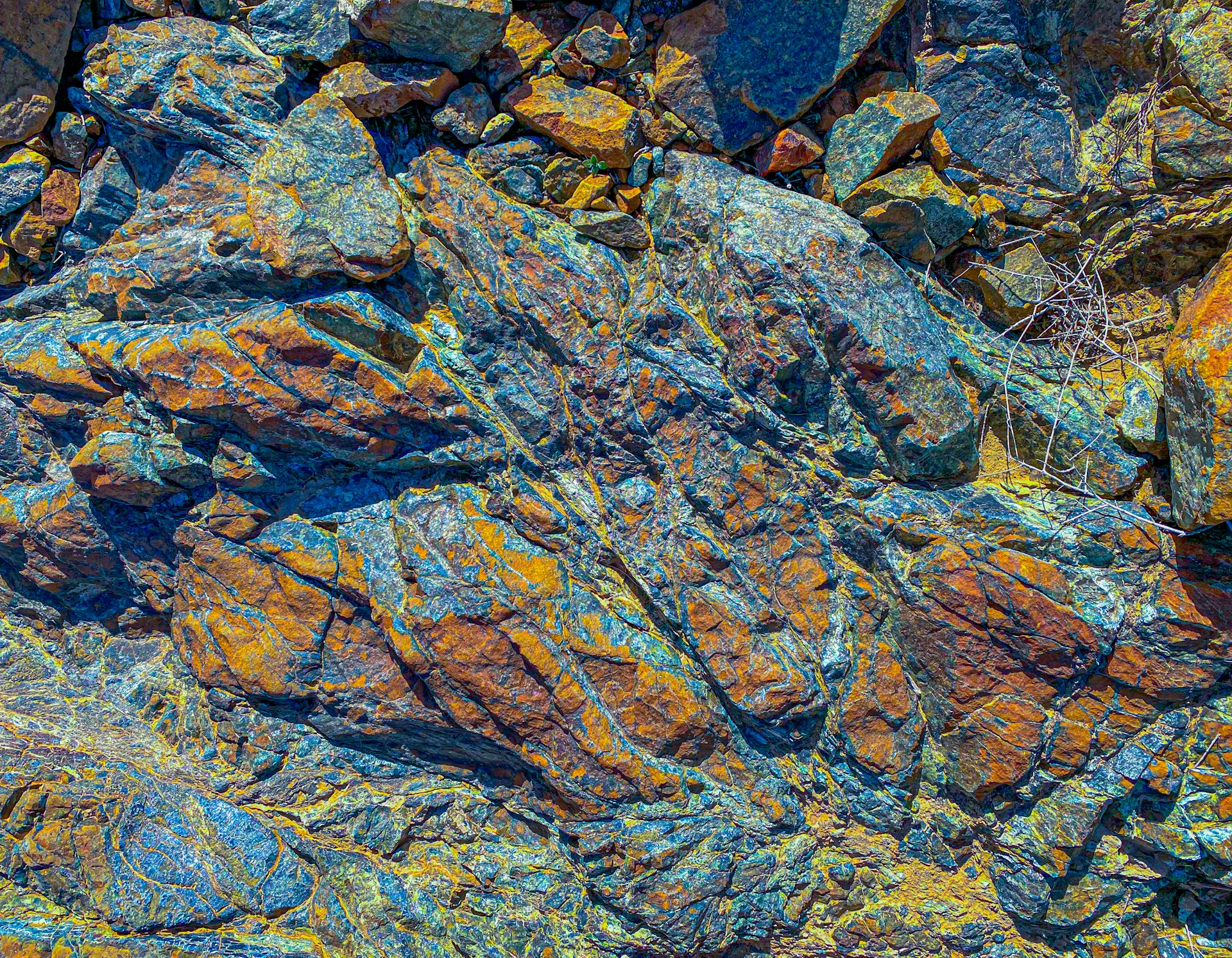a close up of a rock with yellow and blue colors