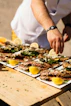 a man is putting lemons on a plate of food