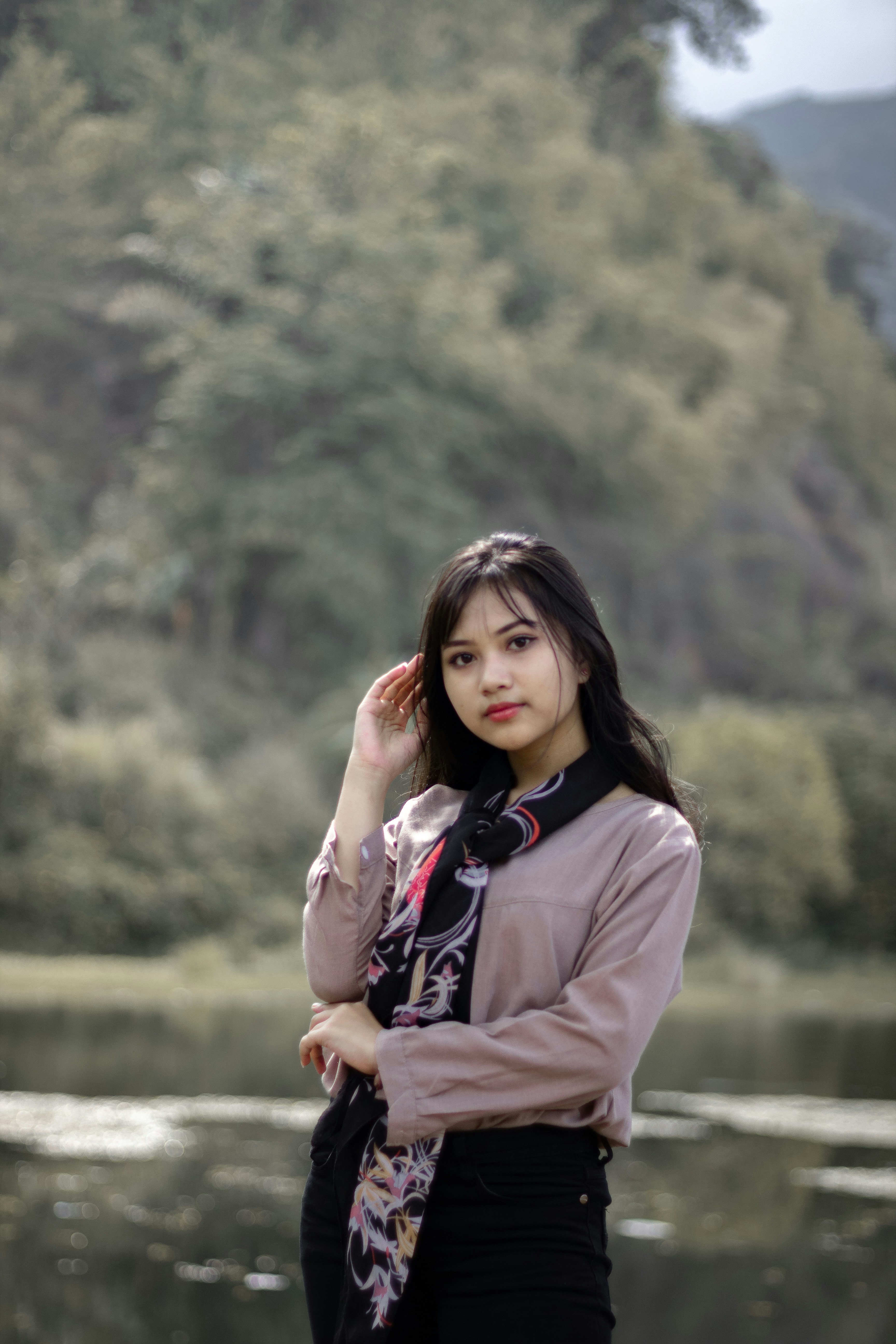 a woman standing in front of a body of water