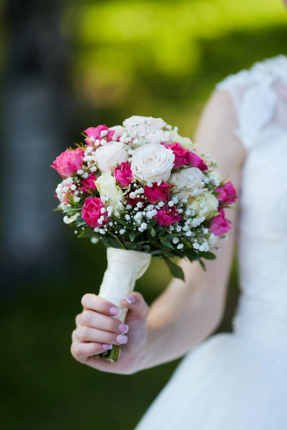 a bride holding a bouquet of flowers in her hand