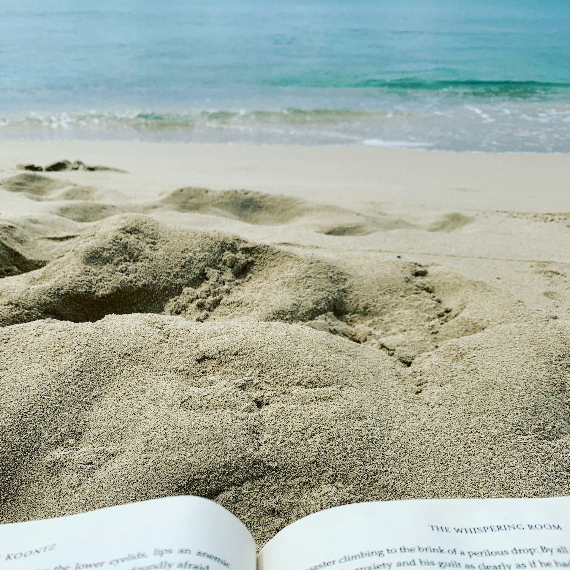 A softly lit cover of a Christian romance novel set on a serene Sea Islands beach at sunset, with gentle waves curling onto the shore.