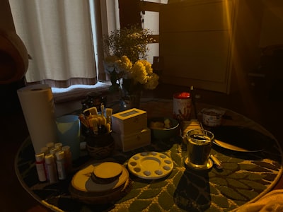 a table with a vase of flowers and other items on it