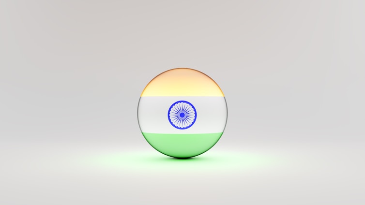 A 3D sphere with the Indian flag design, featuring horizontal stripes of saffron, white with a blue Ashoka Chakra at the center, and green. The sphere is set against a light, neutral background.
