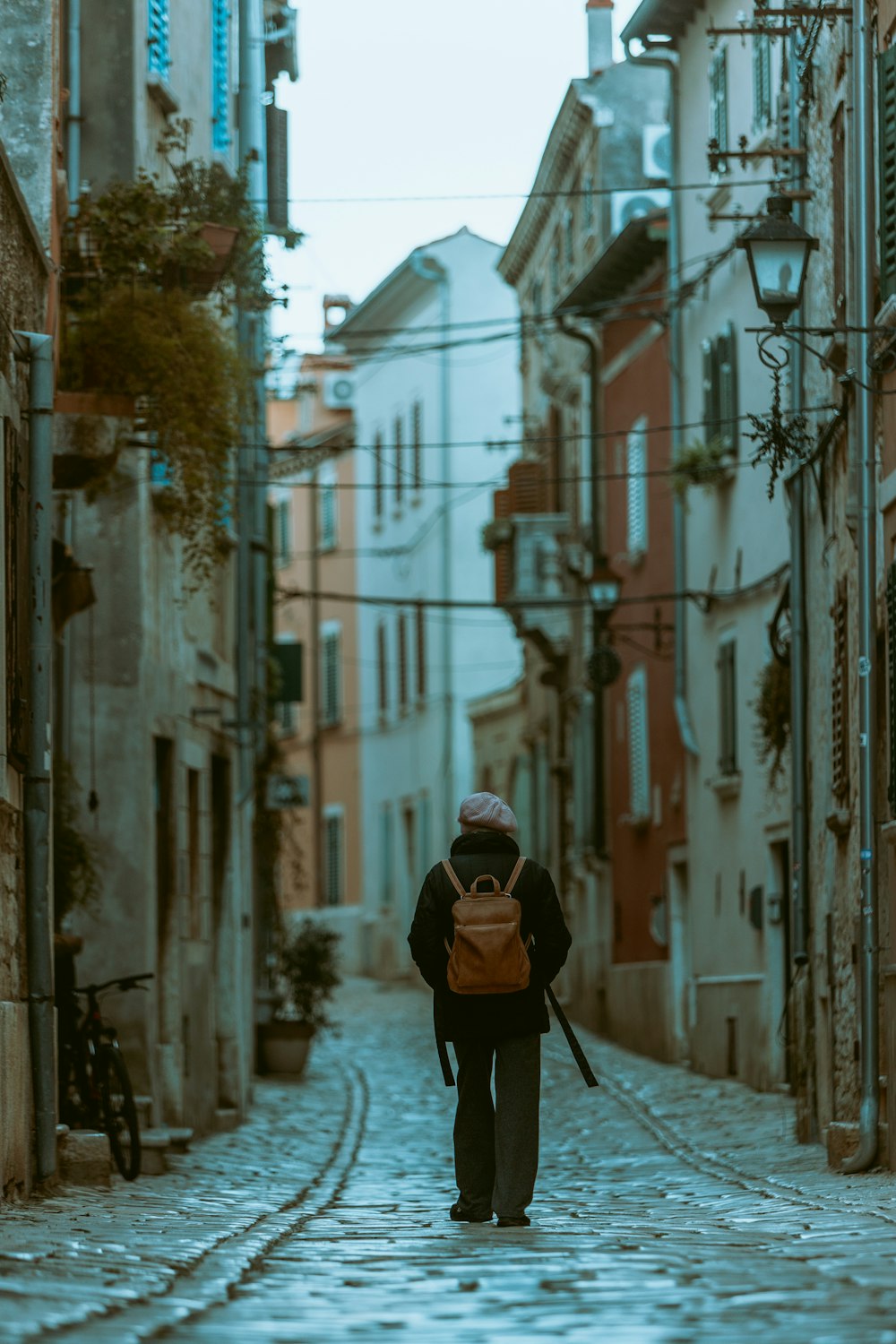 a person with a backpack walking down a street