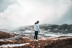 a man standing on top of a snow covered hillside