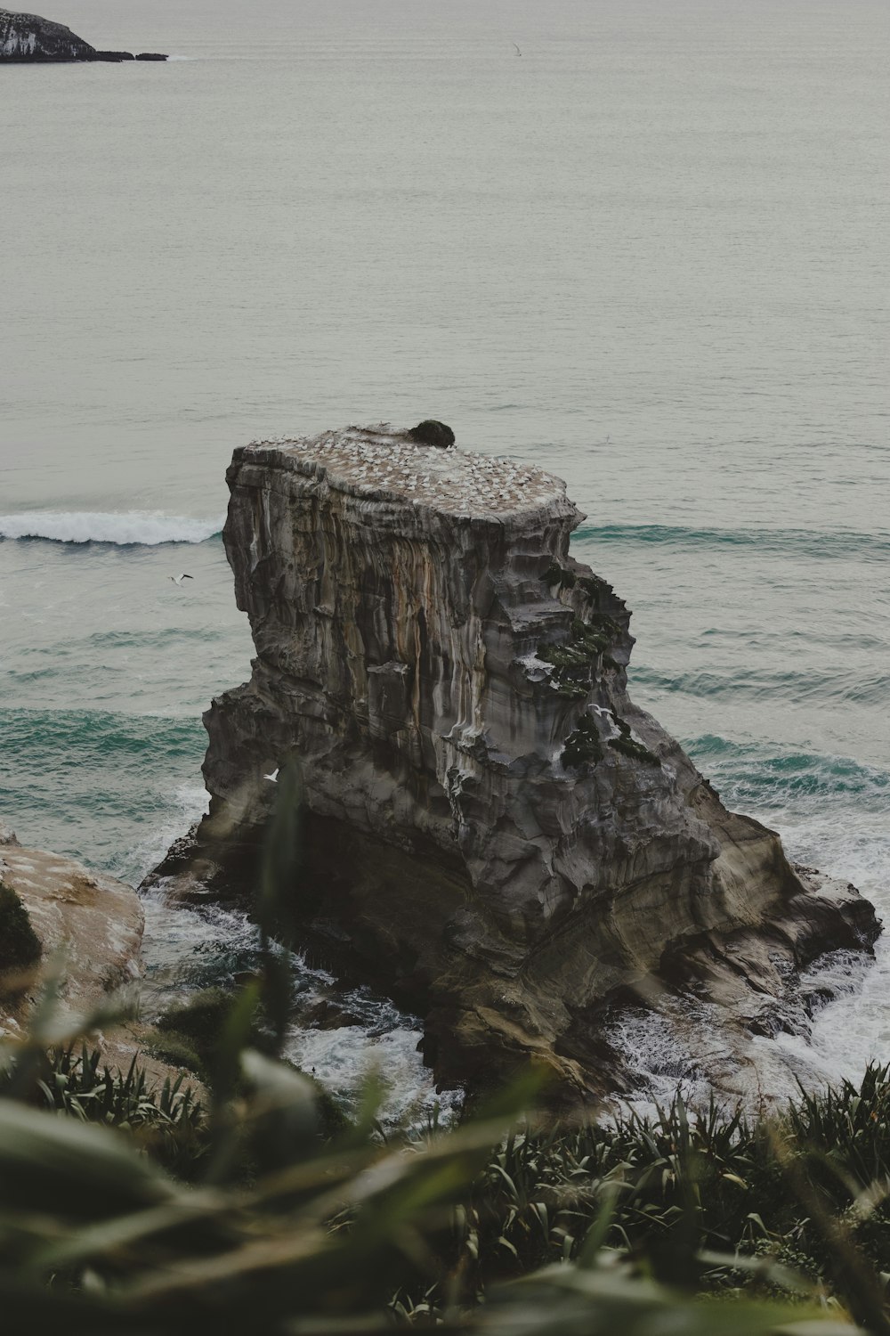 a rock outcropping in the middle of the ocean