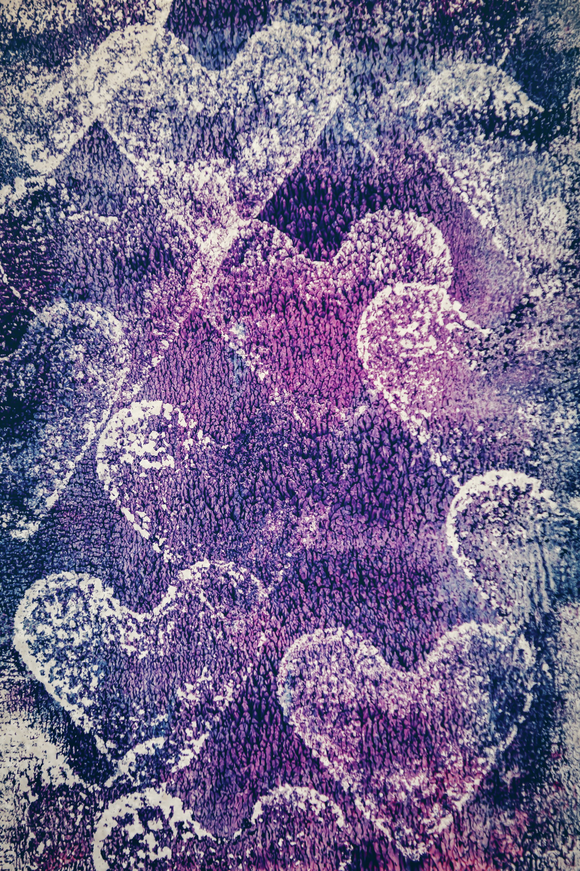 a purple and white rug with hearts on it