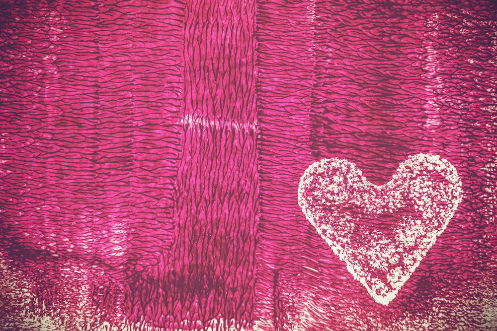 a drawing of a heart on a pink background