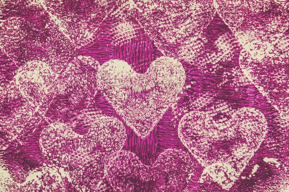 a bunch of hearts on a purple background