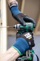 a person with a drill driver on top of a piece of decking