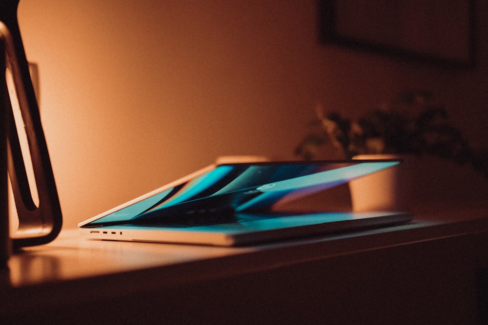 a laptop computer sitting on top of a wooden desk