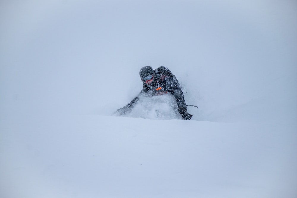 a person is snowboarding down a hill in the snow