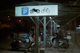Motorcycles and bicycles parked in a designated area with clear markings.