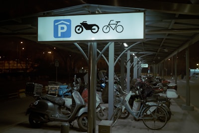 A secure parking area with well-marked spaces near the dharamshala entrance.