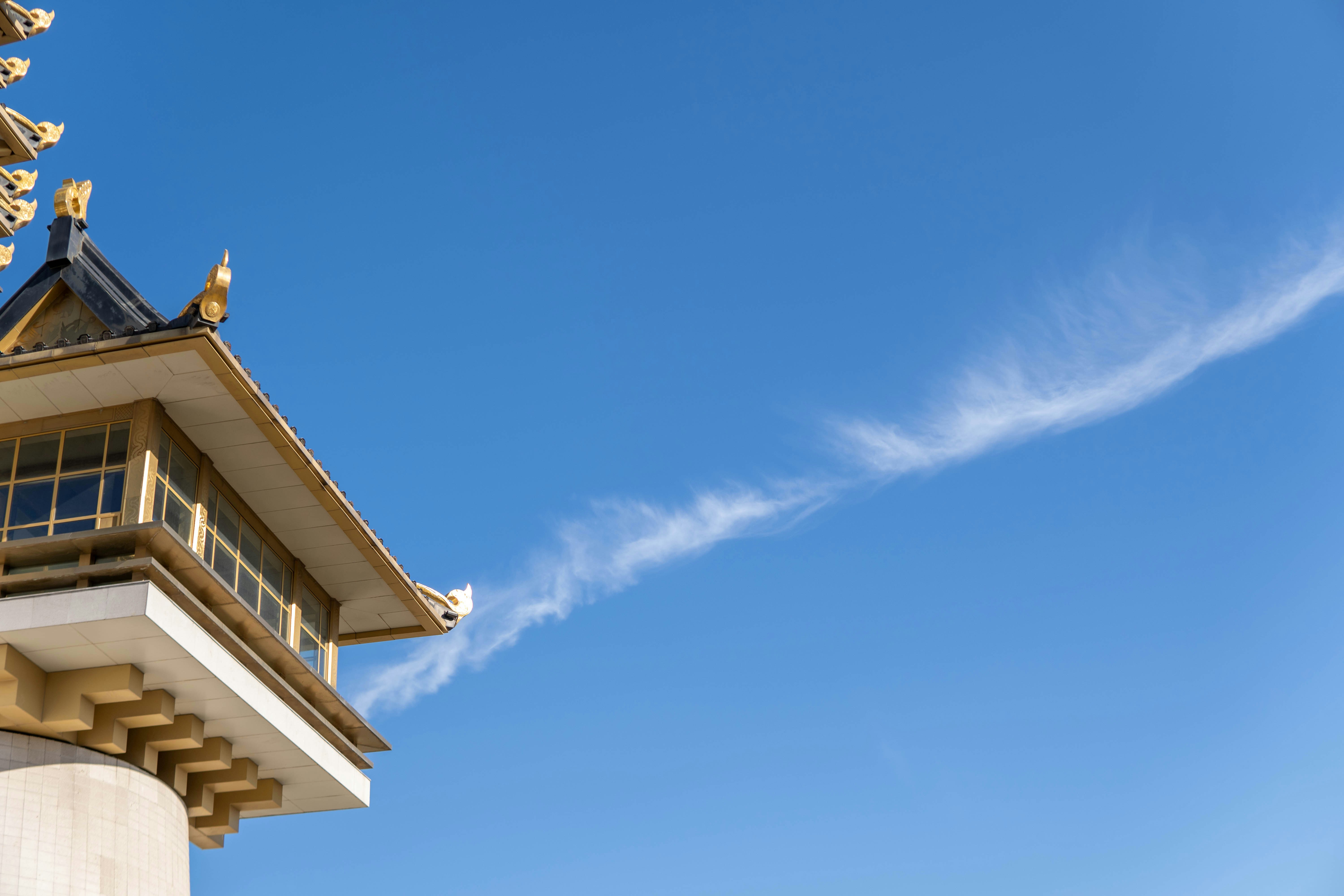 a tall tower with a weather vane on top of it