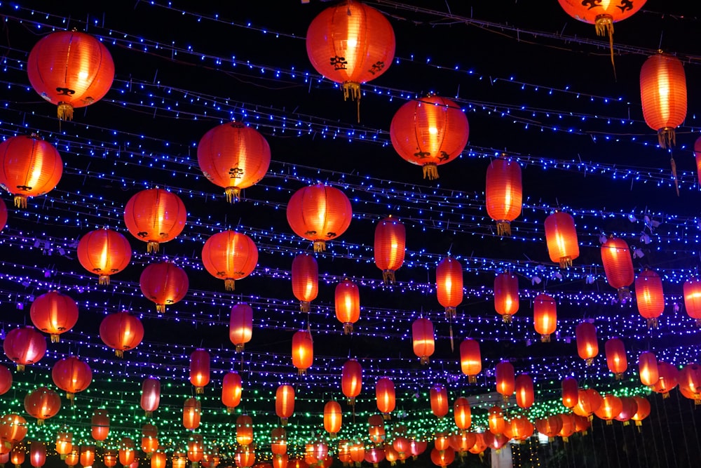 a bunch of red lanterns hanging from the ceiling