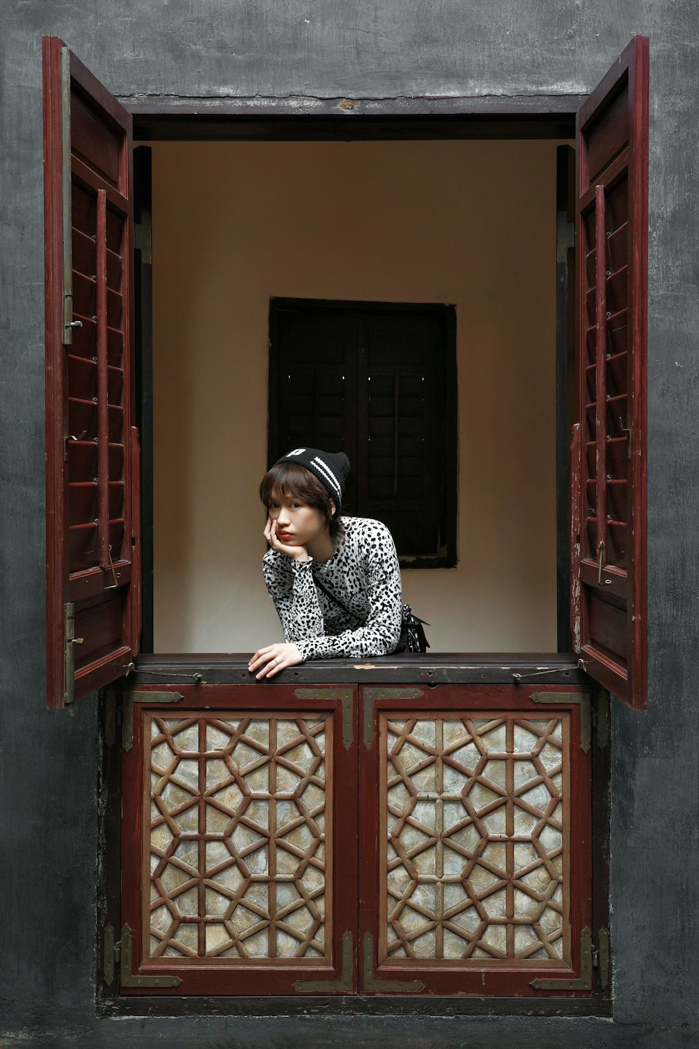 a woman is looking out of a window