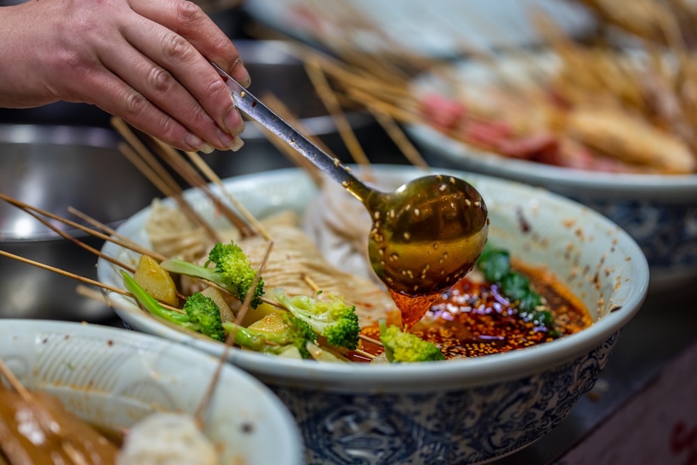 a bowl of food with chopsticks sticking out of it