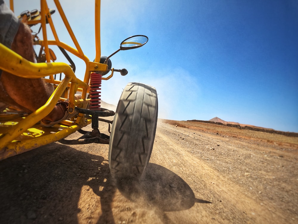 a person riding a buggy on a dirt road