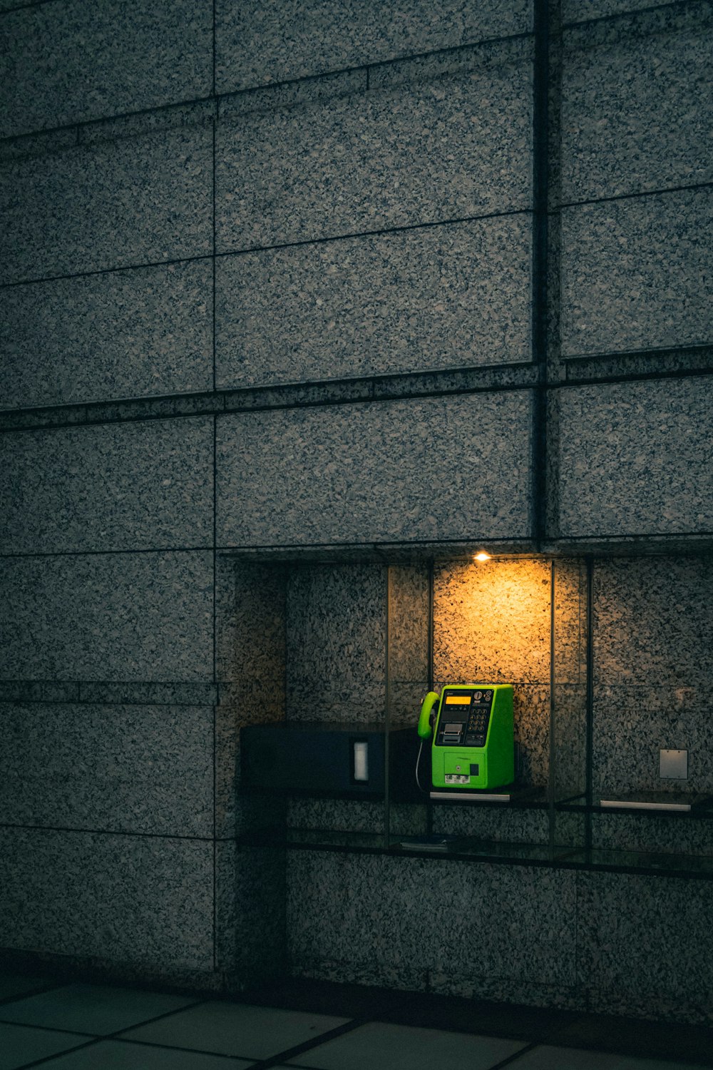 a green bus parked in front of a building