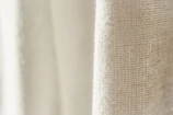 Close-up of textured linen fabric in warm tarçın and kahve shades, highlighting natural fibers