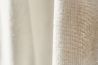 Close-up of the fine linen fabric texture, highlighting the natural weave and softness.