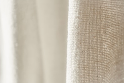 Close-up of fabric texture showing airy, natural linen weave.