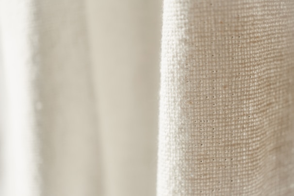 Close-up of soft linen fabric texture in natural light, highlighting breathable weave.