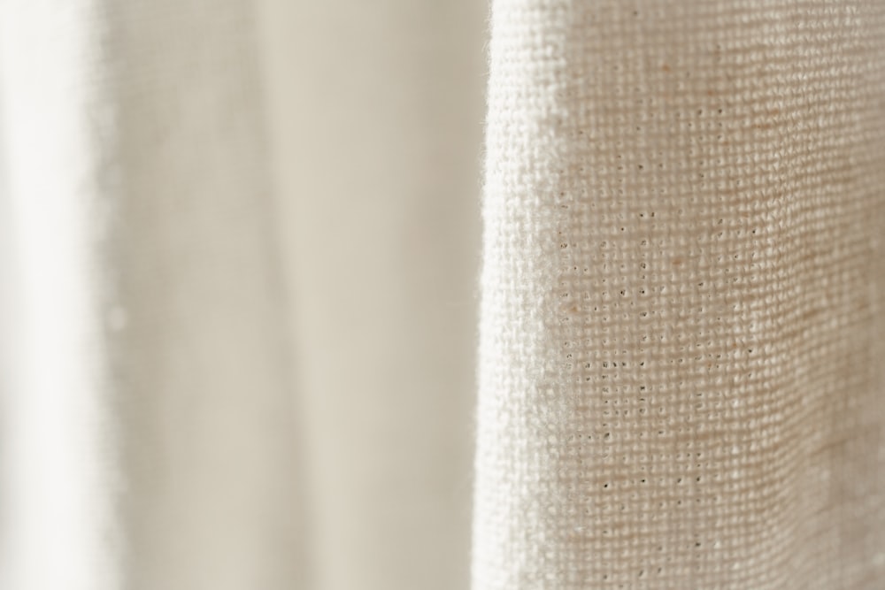 a close up of a curtain with a white background