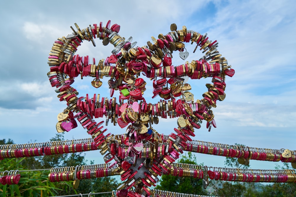 a heart shaped sculpture with many locks attached to it