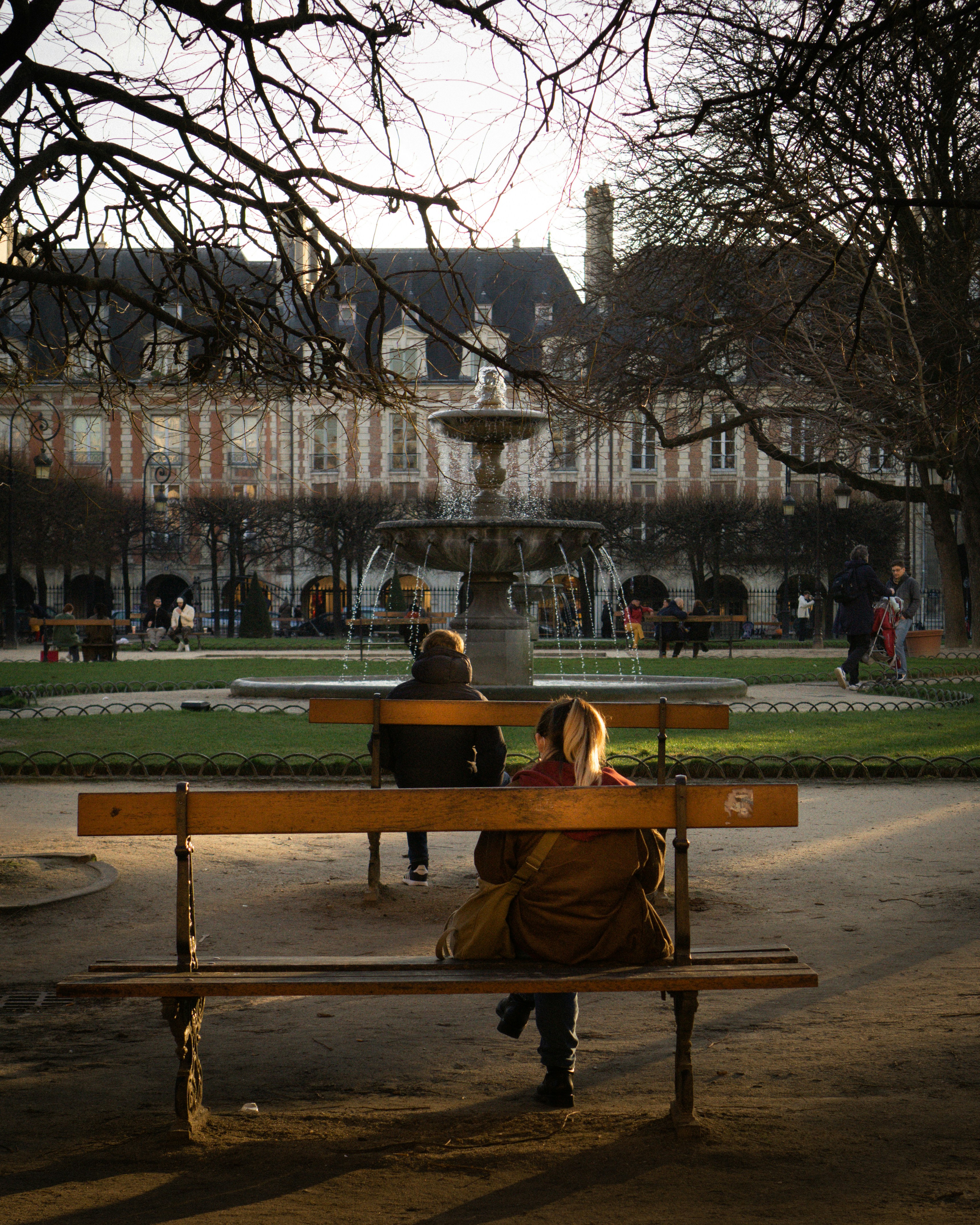 Woman on a bench in Place des Vosges.