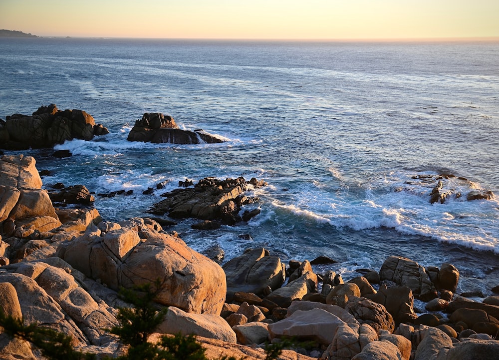 a view of the ocean from a rocky shore