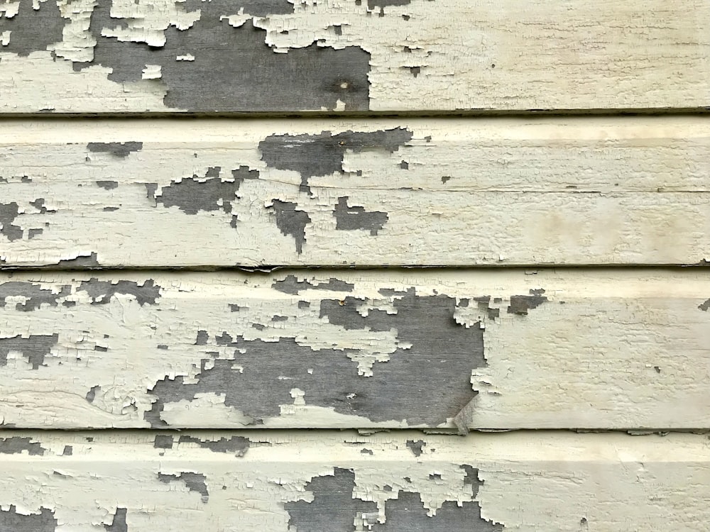 a close up of a wall with peeling paint